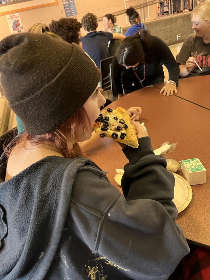 Cavelero Student Olivia King eats a slice of pizza with olives at lunch while enjoying the company of friends. (October 14, 2022 Nickolas Jenkins Morales)
