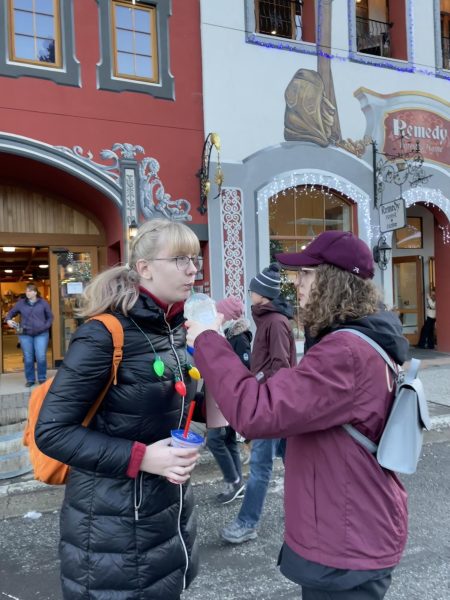 Allison Moore shares her drink with Avery Schildt after running into each other in Leavenworth on December 8th, 2023. Moore states that “friendship means sharing with the ones who you care the most about” (Liah Campbell).
